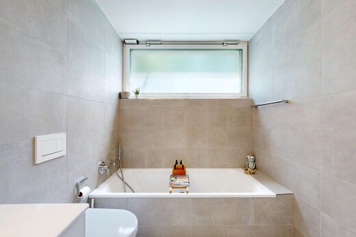 bathroom with tile walls, a bath, and vanity