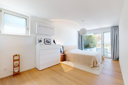 room / bedroom with pendant lighting, access to exterior, and light wood-type flooring