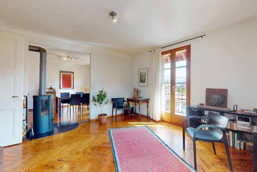 living area featuring french doors and a wood stove
