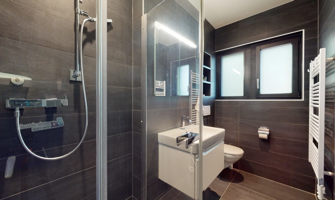 salle de bain avec carrelage, radiateur, toilettes, vasque, miroir, lumière naturelle, mur carrelé, meuble-lavabo, et douche