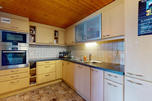 cuisine avec dosseret, four, carrelage, plan de travail, micro-ondes, et plafond de bois