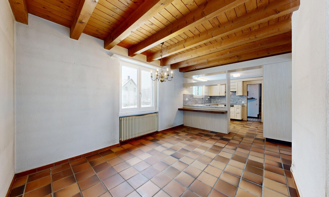 tiled empty room featuring radiator heating unit, a wood ceiling with exposed beams, and a chandelier