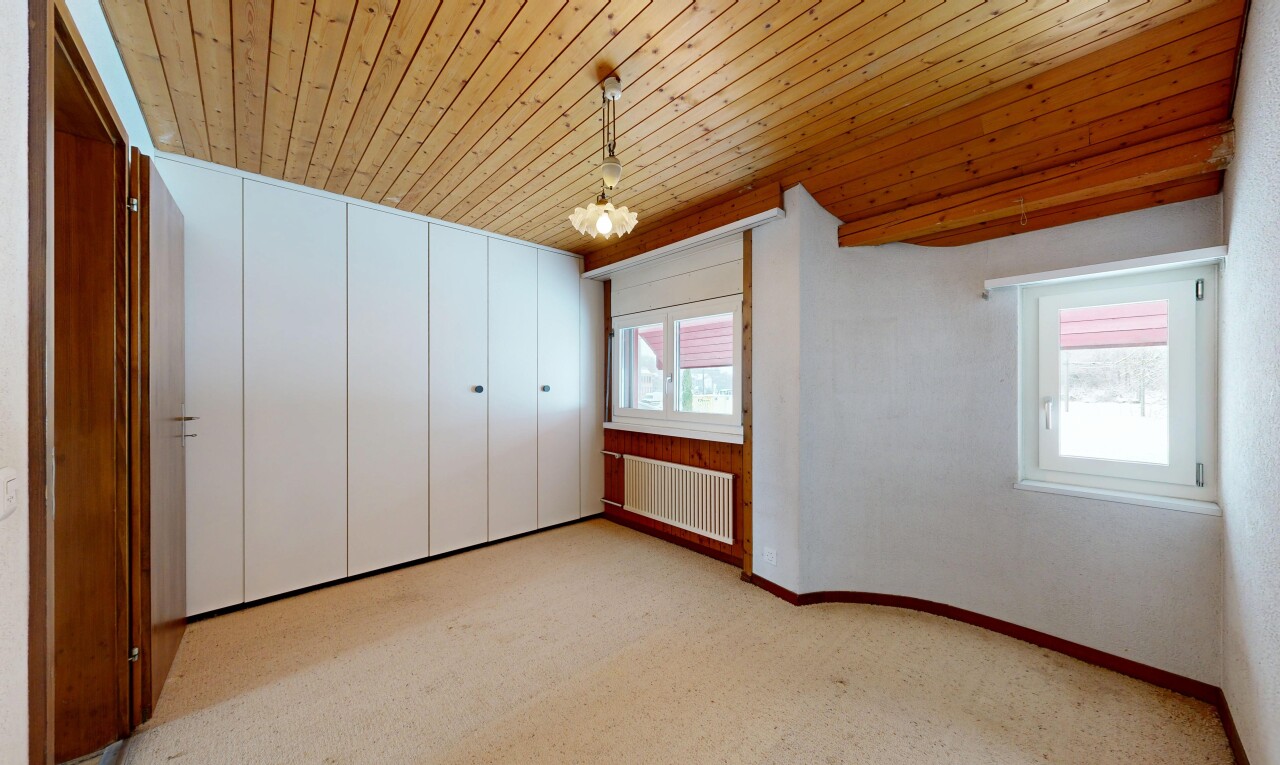 spare room with radiator heating unit, wood ceiling, light colored carpet, and a chandelier