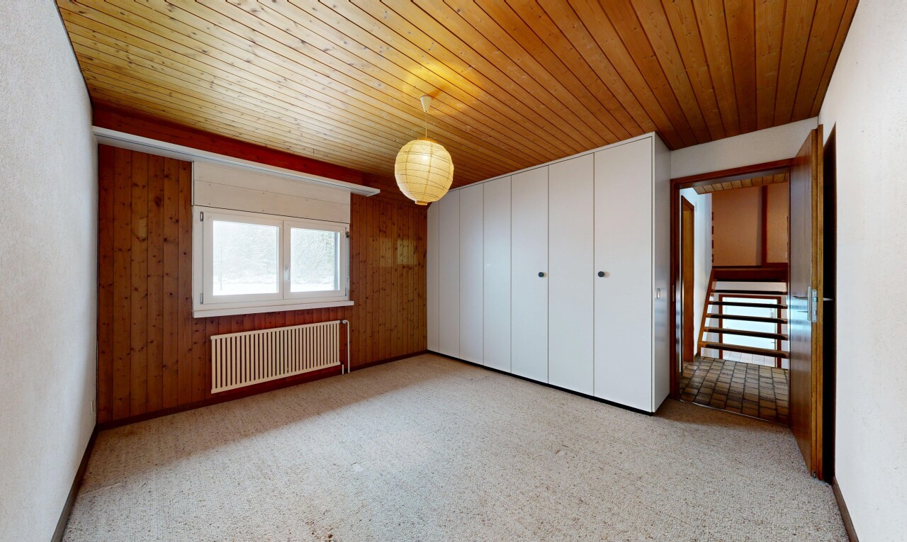 unfurnished room with radiator, wooden walls, and wood ceiling