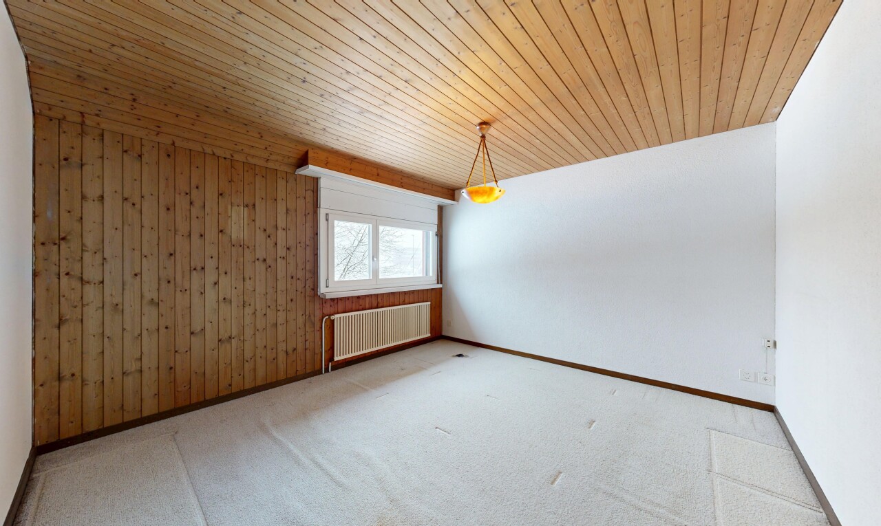 spare room with radiator, wooden ceiling, wood walls, and carpet flooring