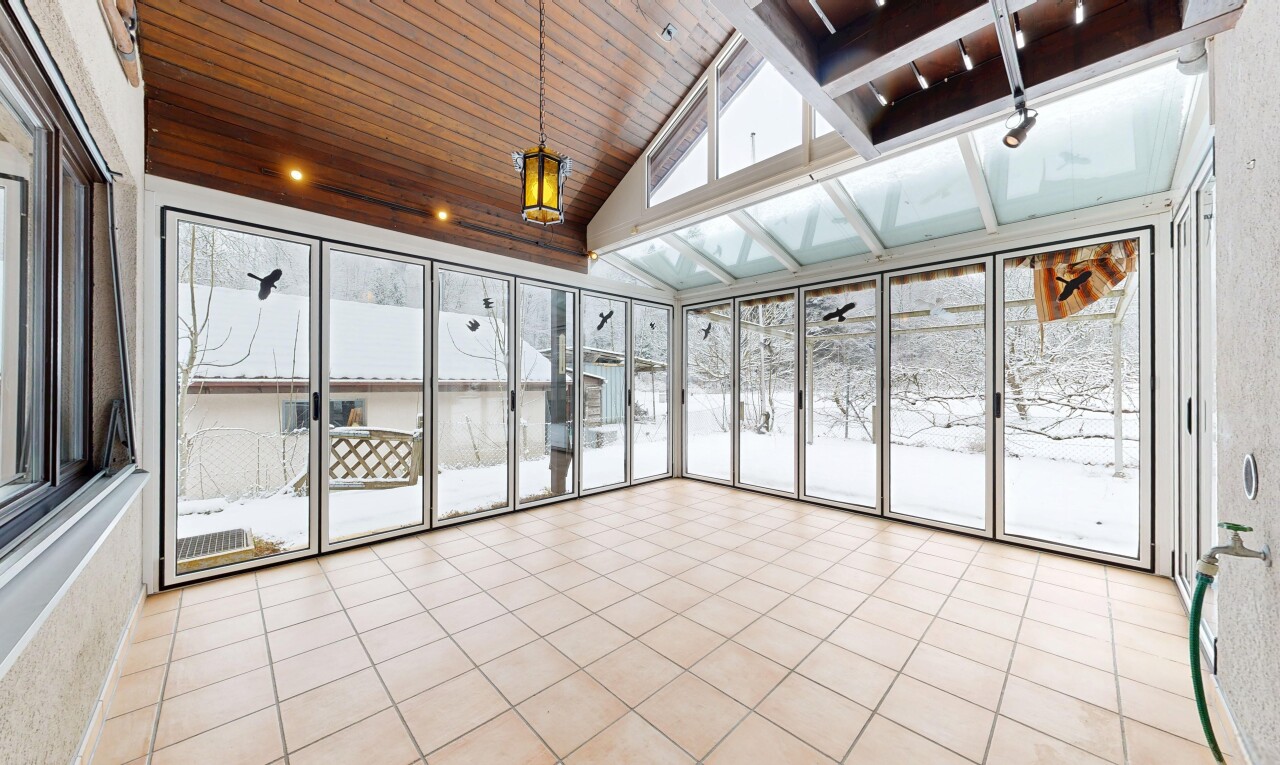 unfurnished room with lofted ceiling, wood ceiling, light tile patterned floors, and expansive windows