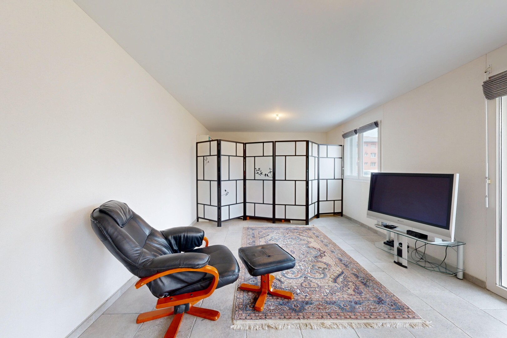 salon avec télévision, cloison sèche, drywall, inside property, et lumière naturelle