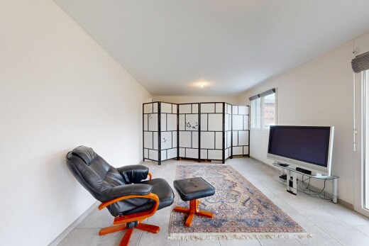 living room featuring light tile patterned floors and baseboards