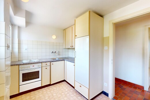 küche mit ofen, inside property, cremefarbene schränke, küchenrückwand beim herd, und küchenrückwand beim Herd