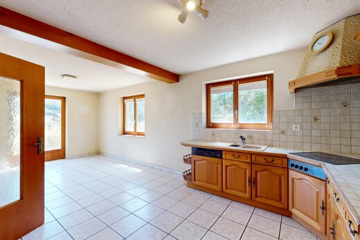 kitchen with tile countertops, range hood, tasteful backsplash, beam ceiling, and black electric cooktop