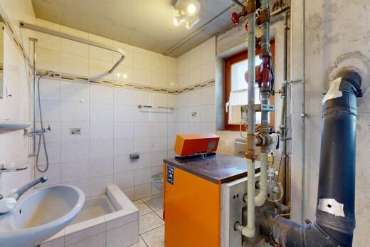 bathroom with a tile shower, tile walls, and light tile patterned floors