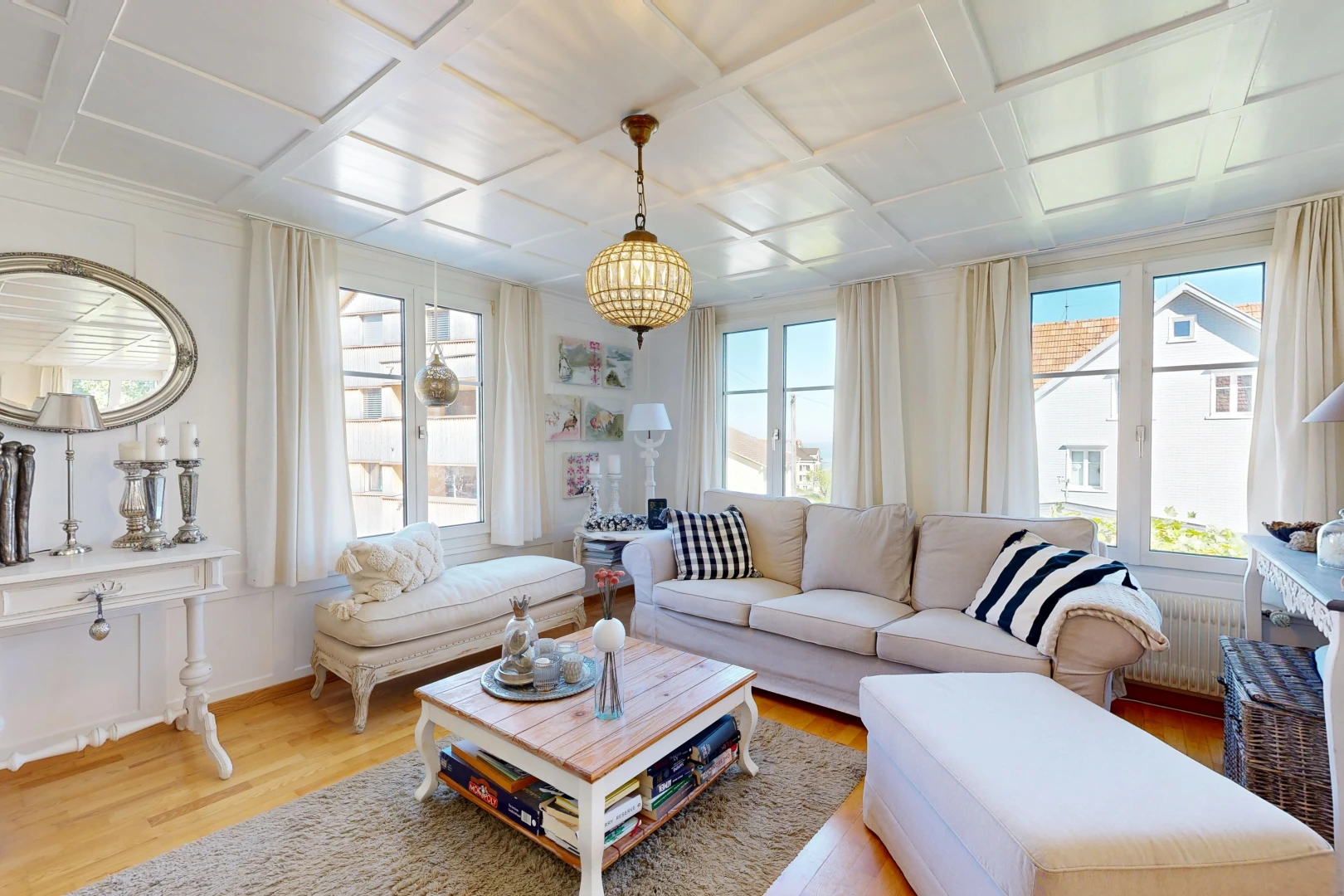 living room with coffered ceiling, healthy amount of natural light, light wood-style flooring, and radiator heating unit