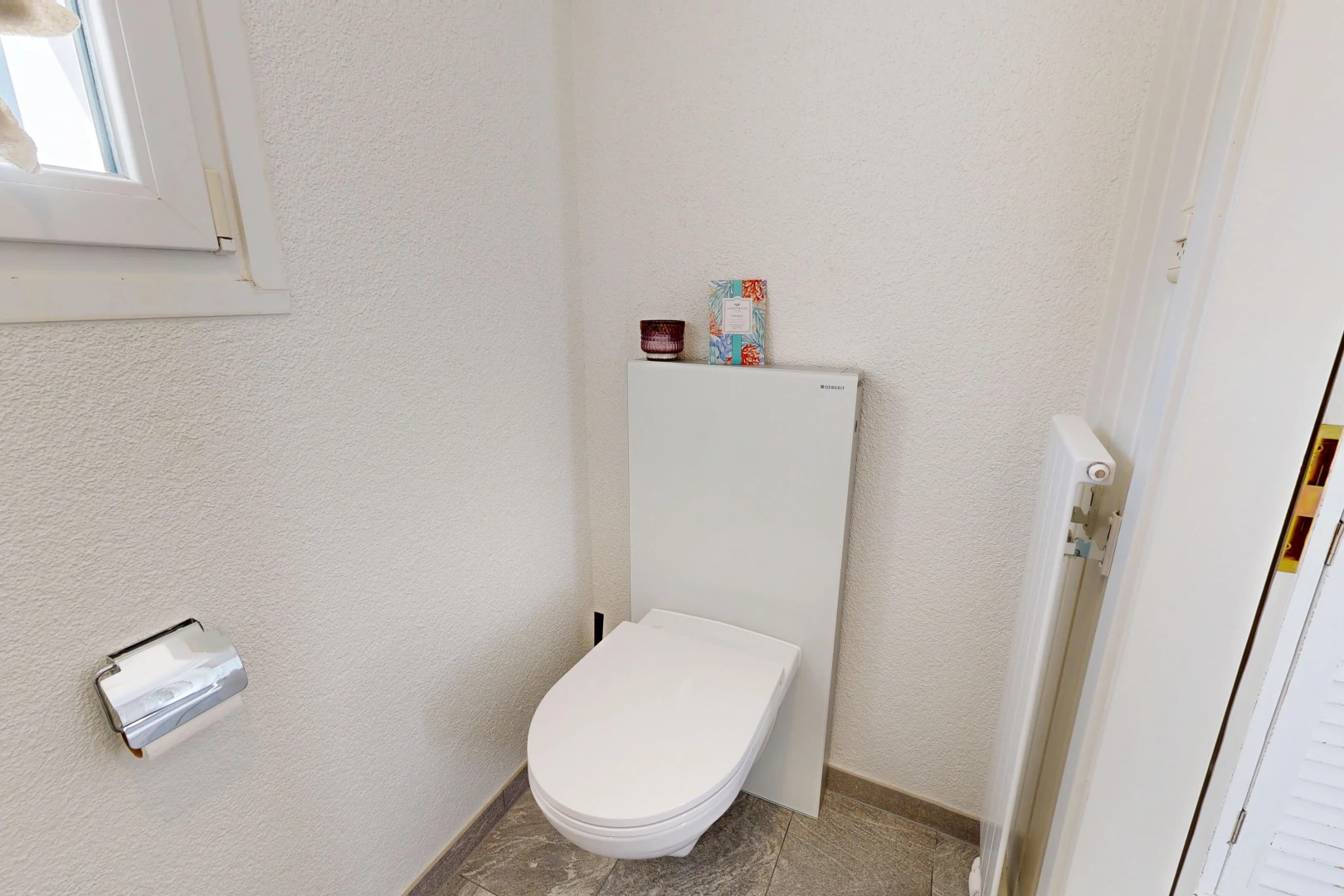 bathroom with toilet and a textured wall