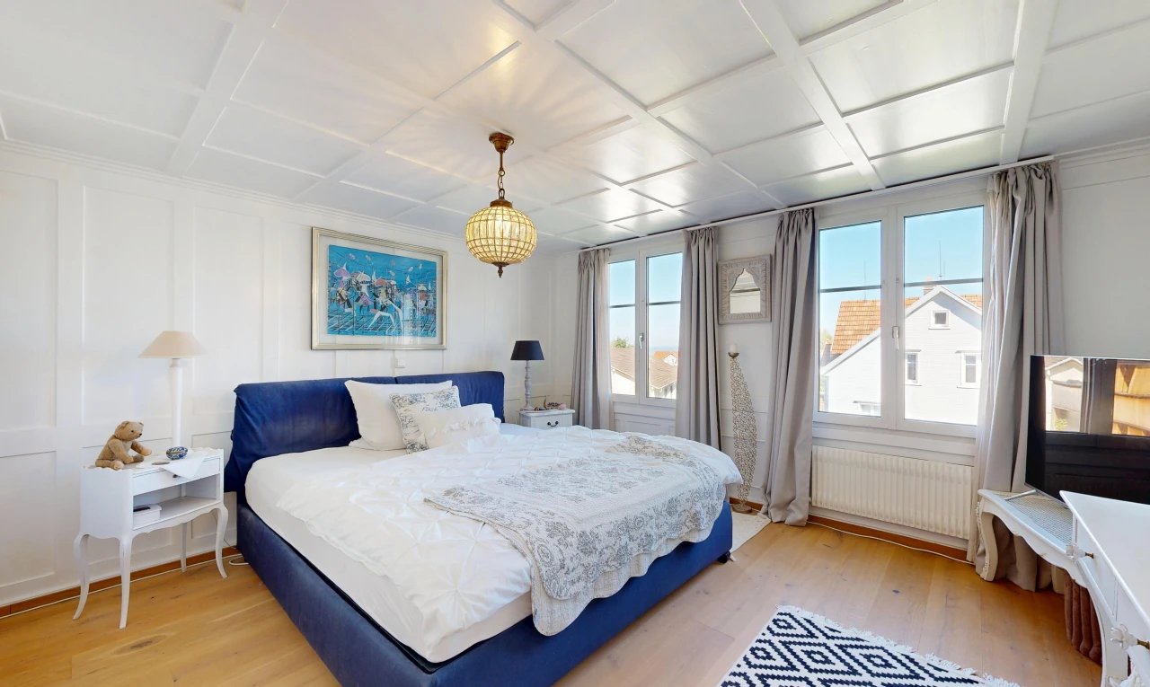 room with radiator heating unit, coffered ceiling, light wood-type flooring, and pendant lighting