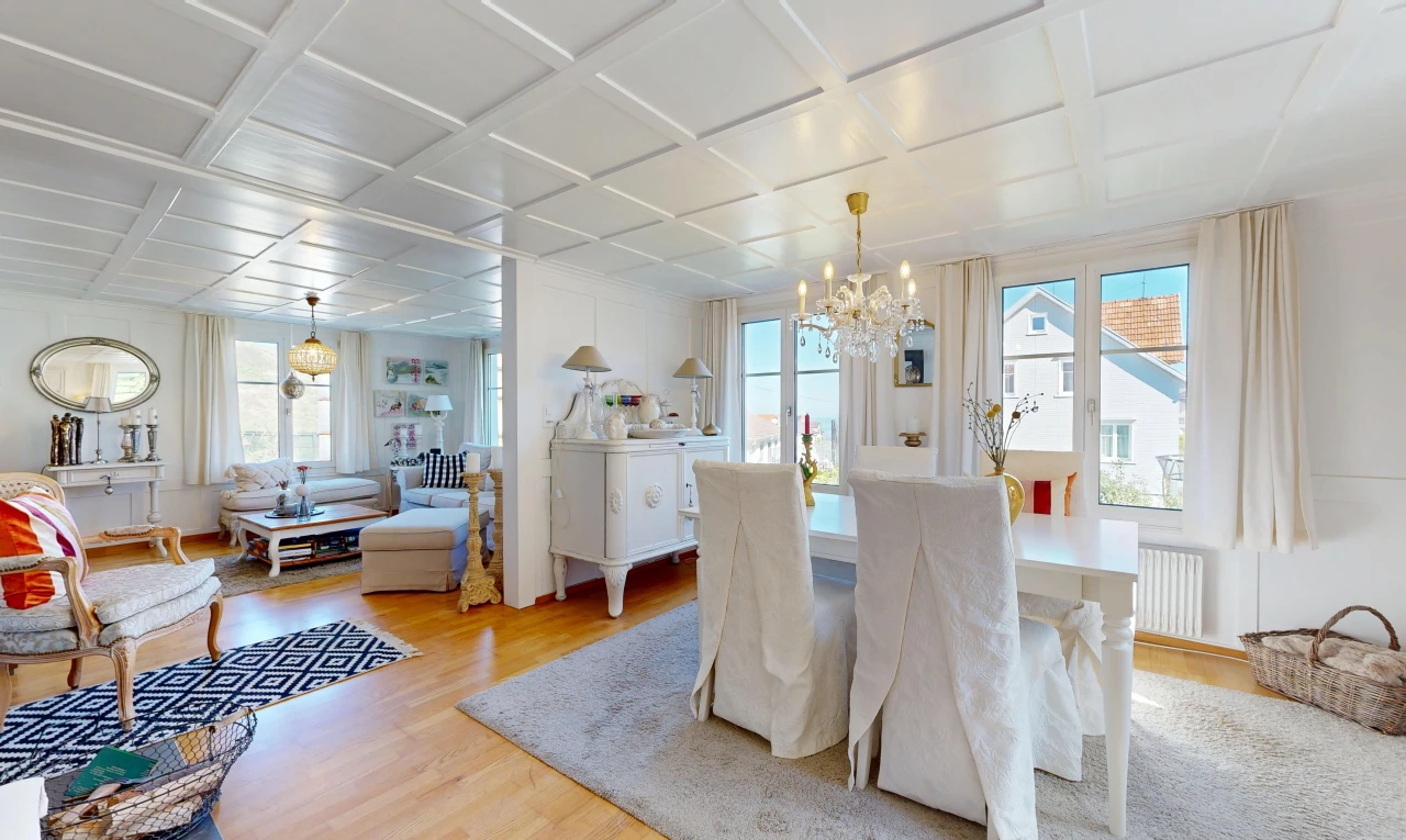 living room featuring coffered ceiling, light wood finished floors, and radiator heating unit