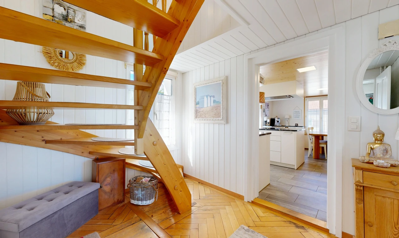 staircase featuring parquet floors and wood walls