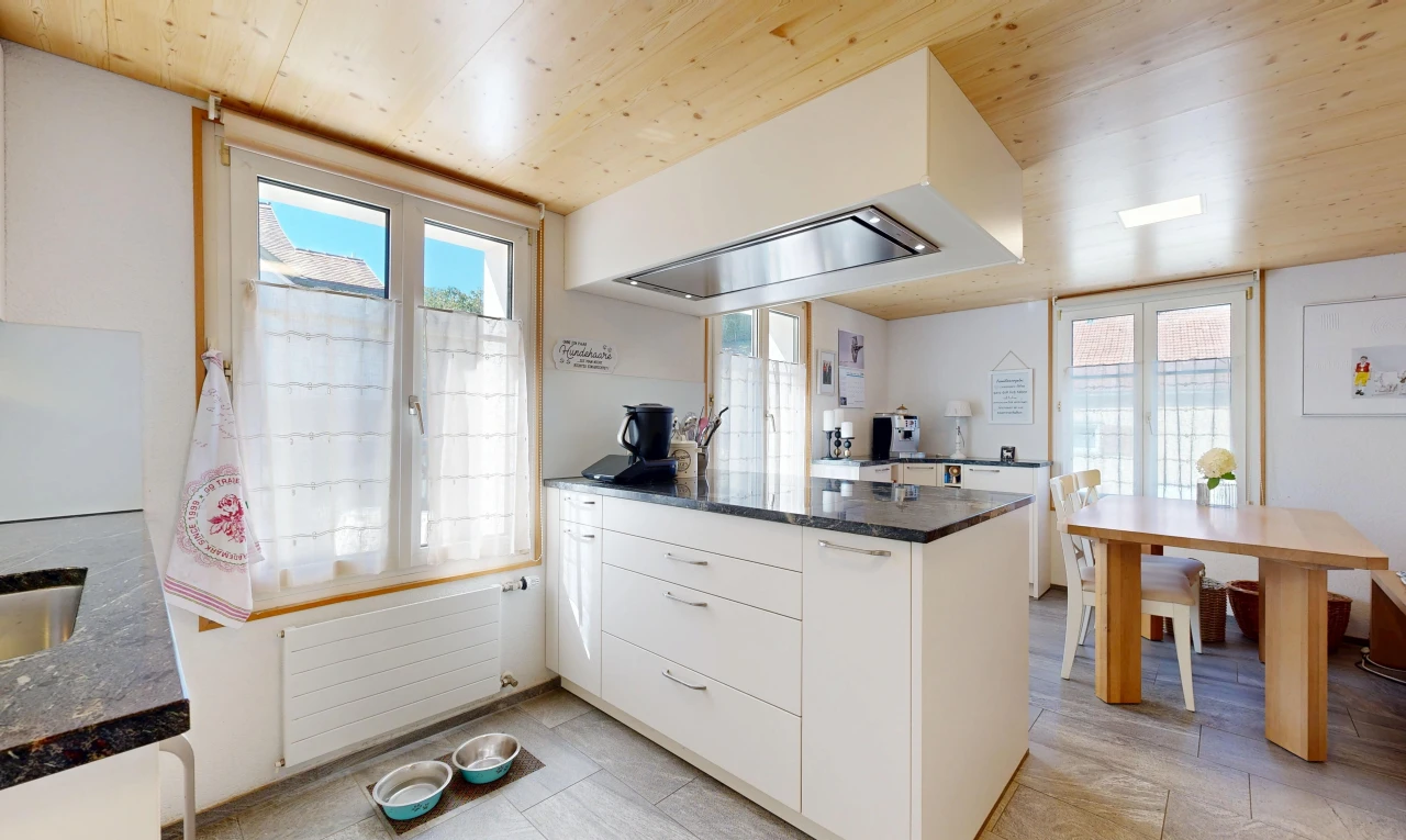 kitchen featuring radiator heating unit, wooden ceiling, white cabinets, access to outside, and a peninsula