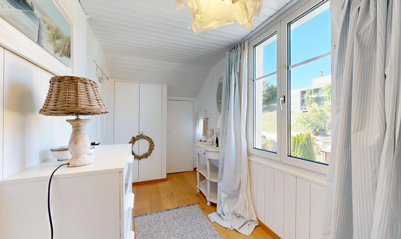 hallway featuring light wood-style floors, a closet, and wood walls