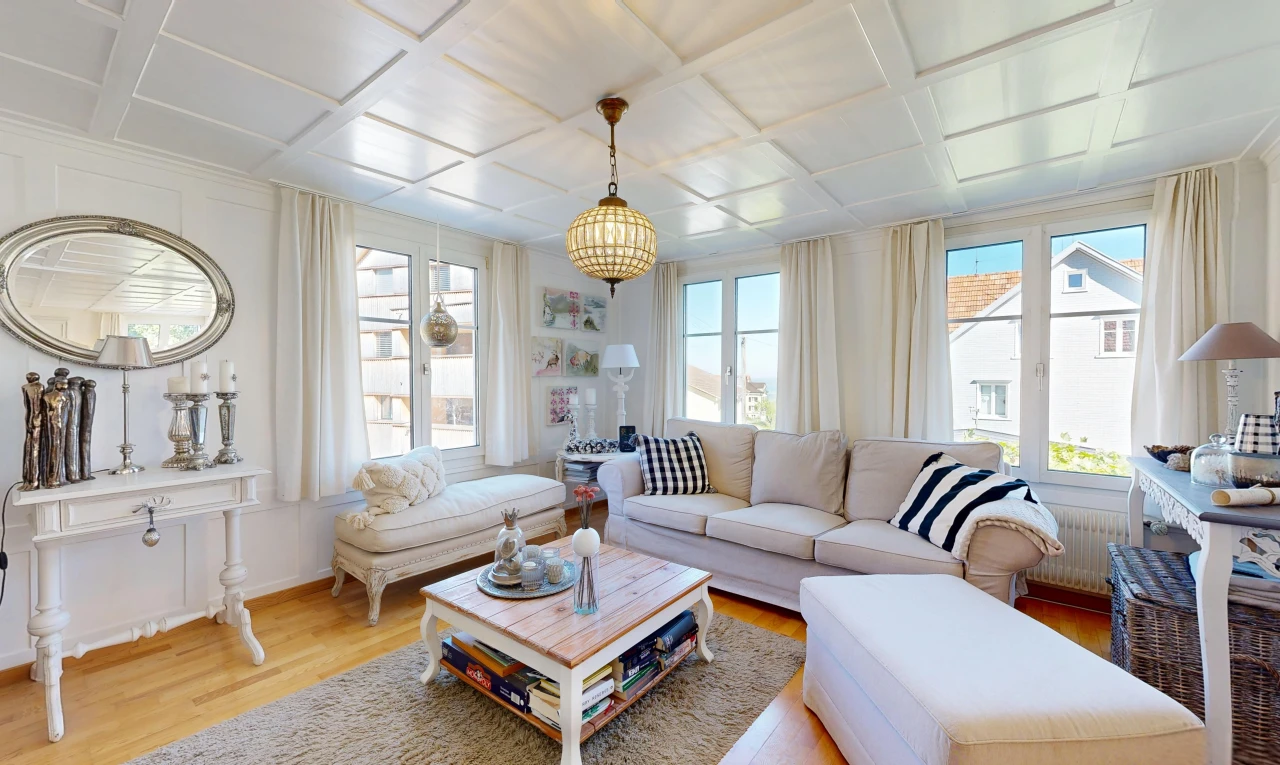 living room with coffered ceiling, healthy amount of natural light, light wood-style flooring, and radiator heating unit
