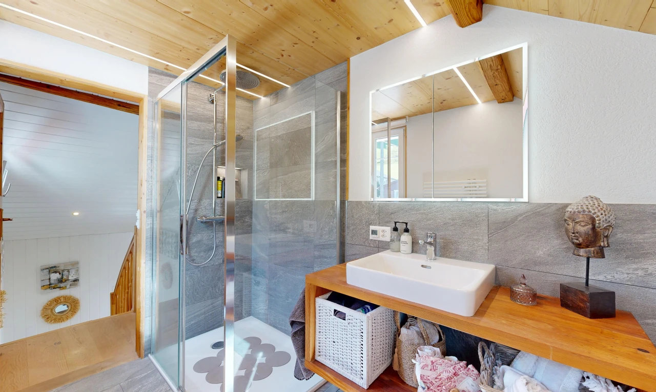bathroom with a shower stall, wood ceiling, and vanity