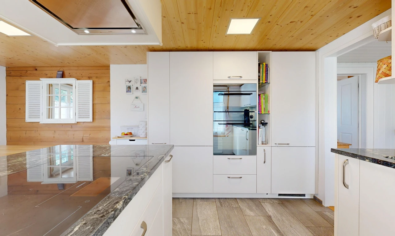 kitchen with wood ceiling, range hood, white cabinetry, dark stone countertops, and black appliances
