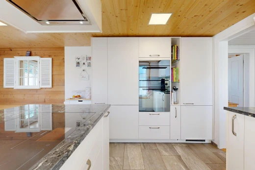 kitchen with wood ceiling, range hood, white cabinetry, dark stone countertops, and black appliances