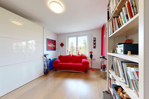 living area with built in shelves and light wood-style flooring