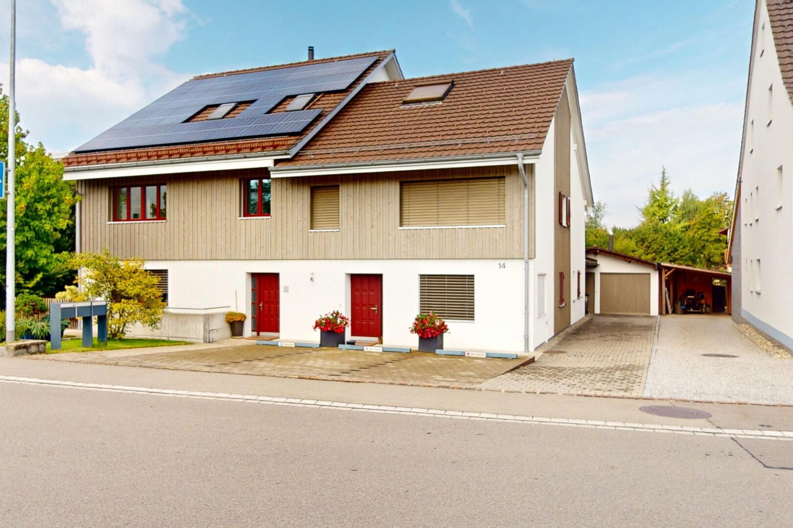 façade avec property visible, bardage vertical, day time, et panneaux solaires