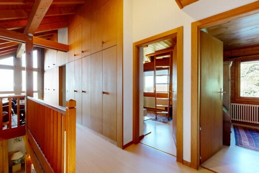 corridor with radiator, vaulted ceiling with beams, light wood-style flooring, wooden ceiling, and an upstairs landing