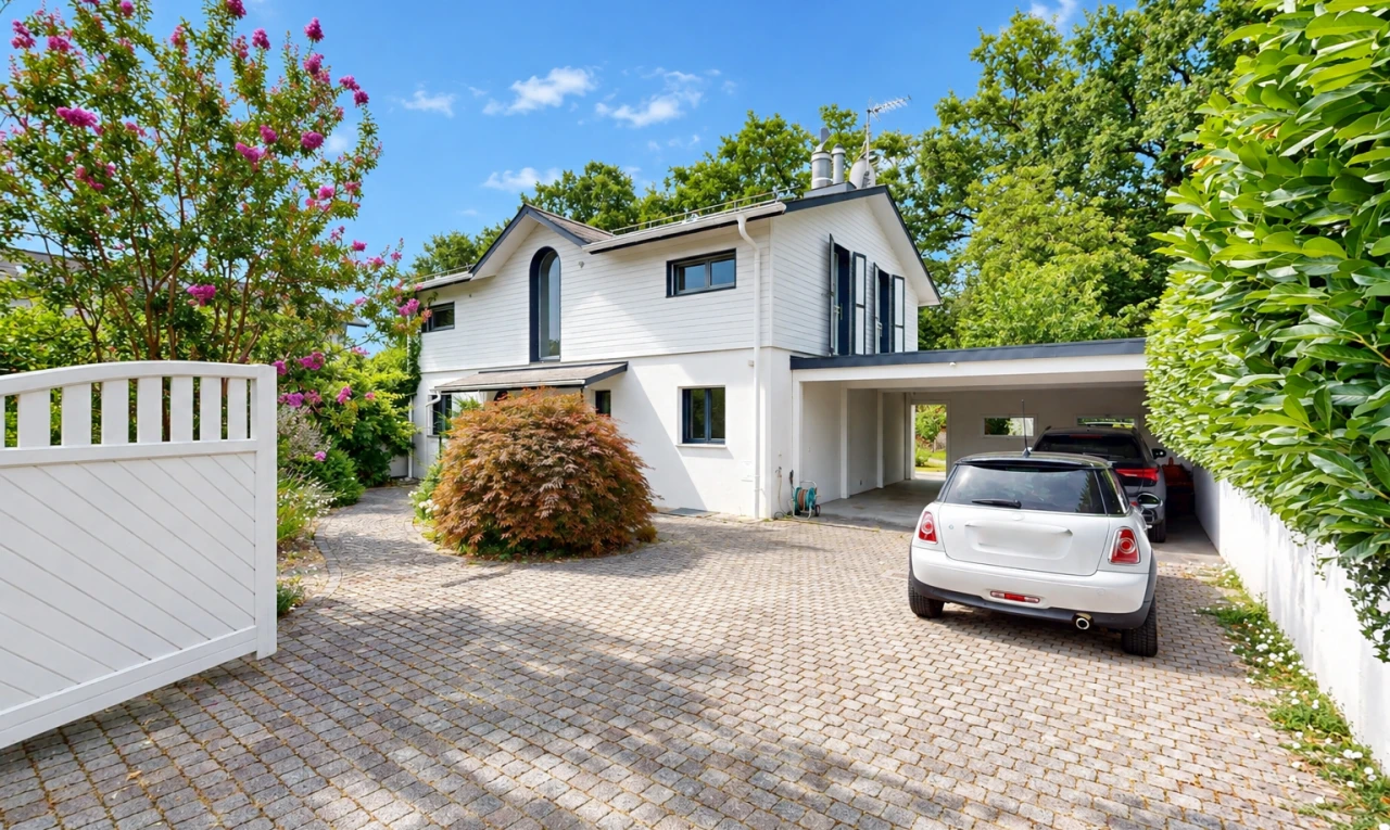 view of property featuring driveway and a carport