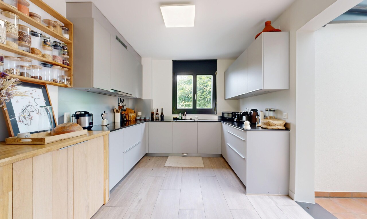 kitchen with dual tone cabinetry, modern cabinets, dark countertops, and open shelves