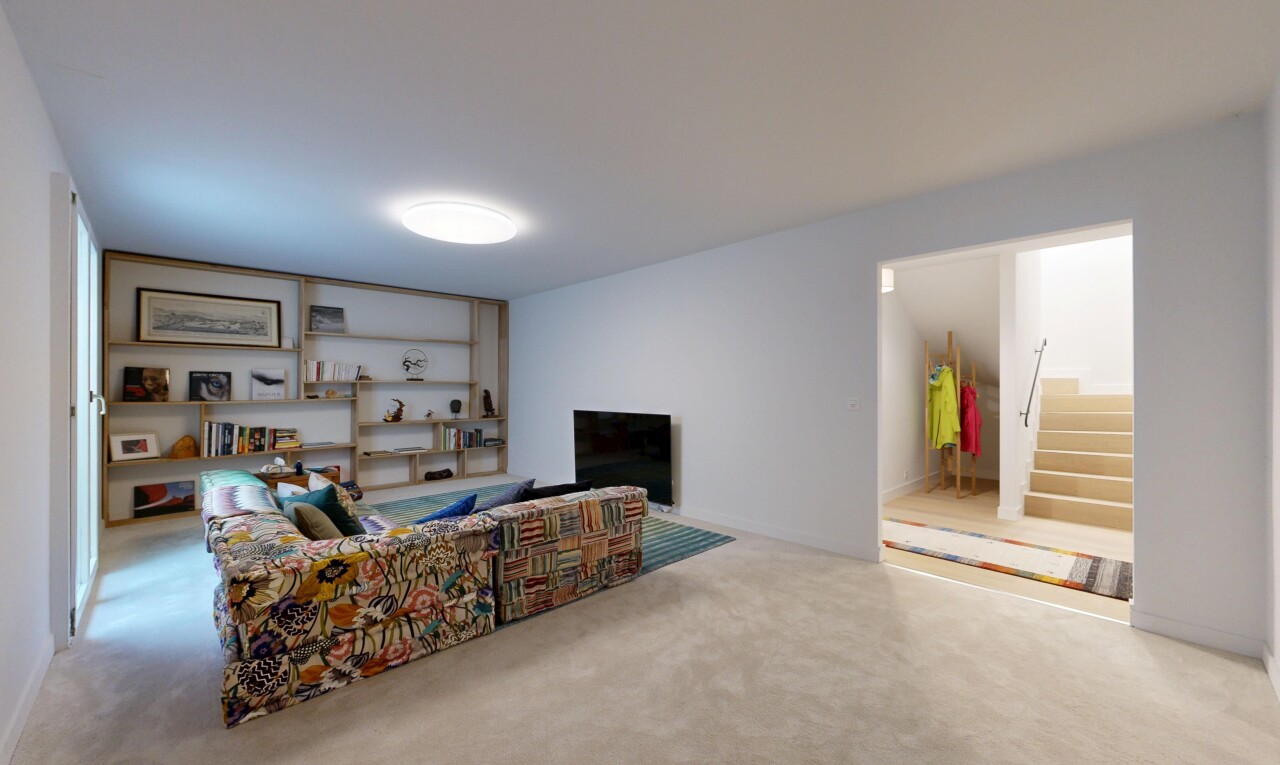 carpeted living room with stairs