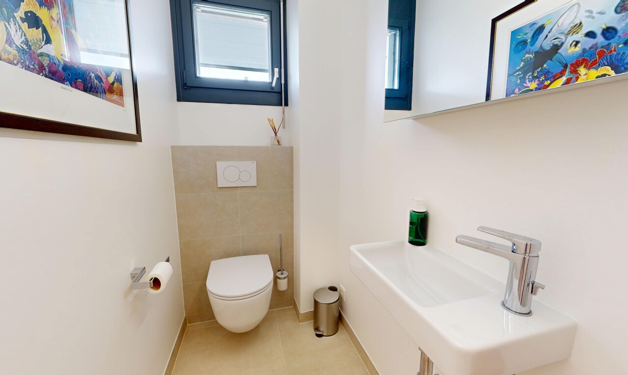 half bathroom with a sink and light tile patterned floors