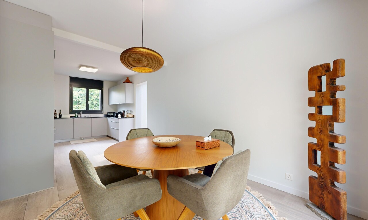 dining room with hanging light fixtures and light wood-type flooring