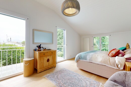 room / bedroom featuring access to outside, vaulted ceiling, light wood-style flooring, and decorative light fixtures