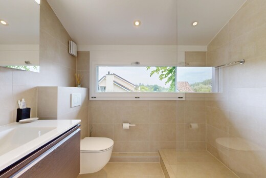bathroom featuring tile walls, vanity, walk in shower, and recessed lighting