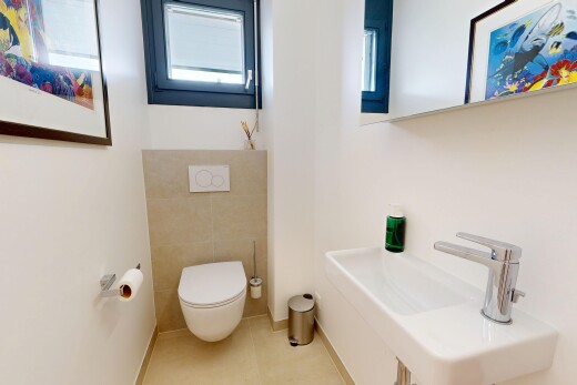 half bathroom with a sink and light tile patterned floors