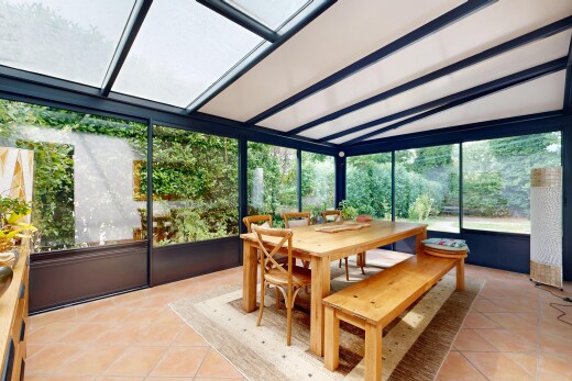 dining space with light tile patterned floors and vaulted ceiling