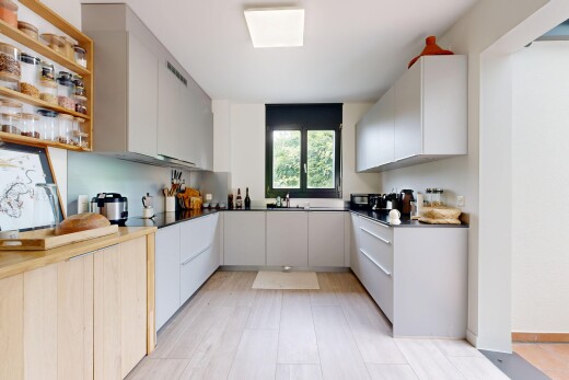 kitchen with dual tone cabinetry, modern cabinets, dark countertops, and open shelves