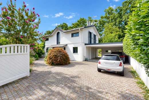 view of property featuring driveway and a carport