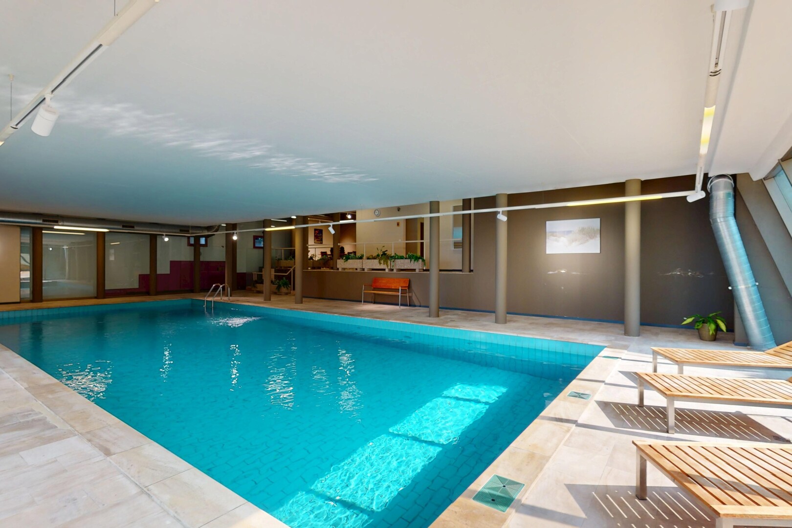 indoor pool featuring a patio area