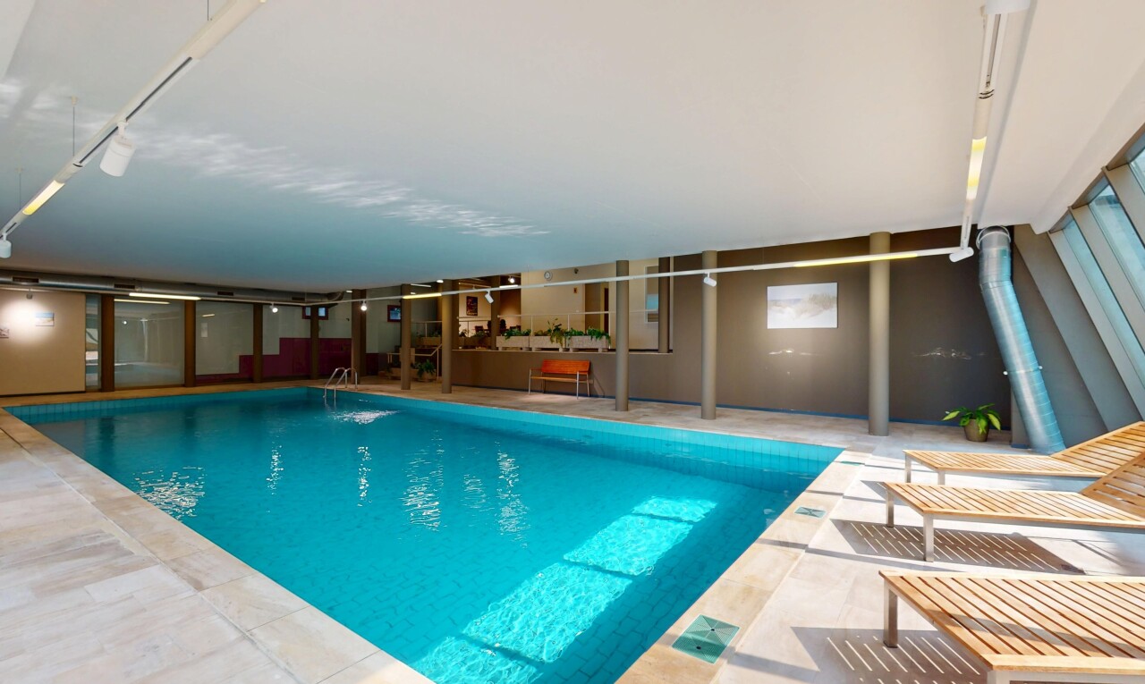 indoor pool featuring a patio area