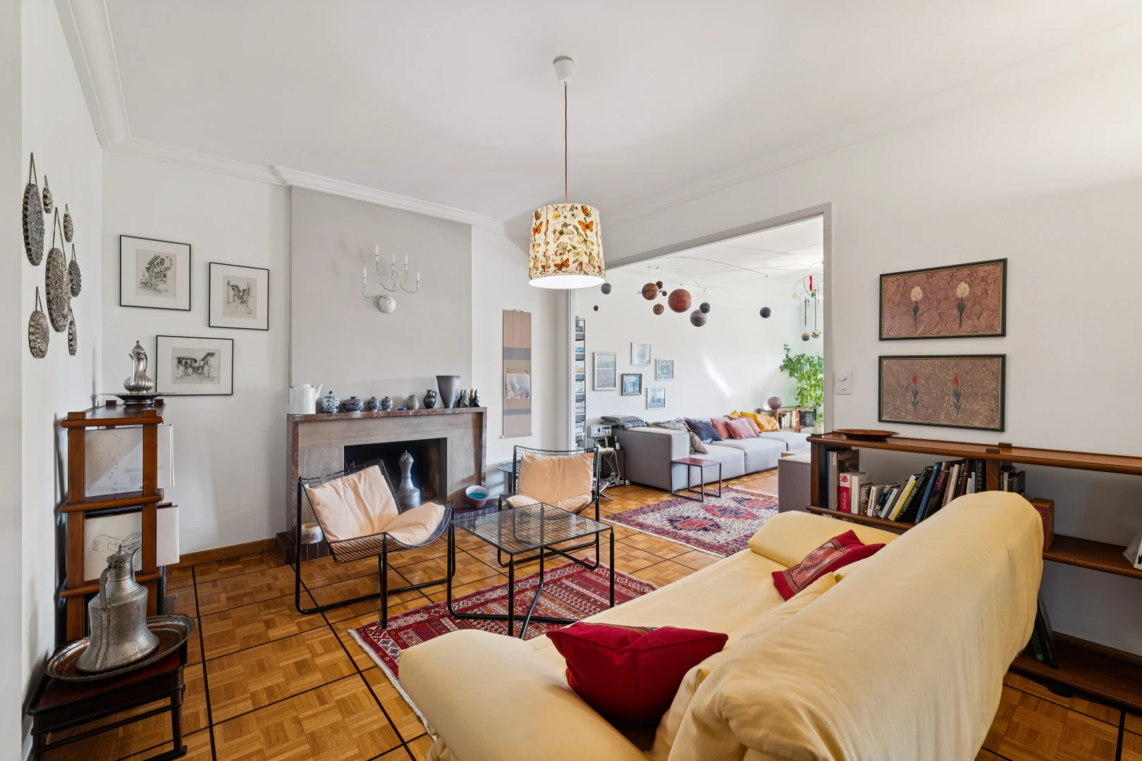 living room with decorative light fixtures, parquet floors, crown molding, and a fireplace
