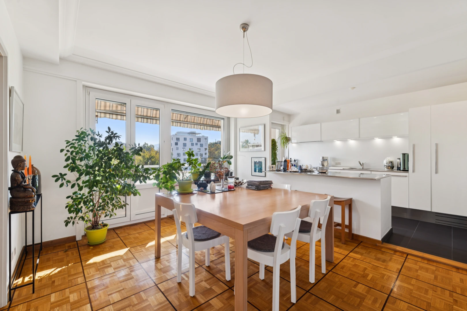 dining space with decorative light fixtures and parquet floors