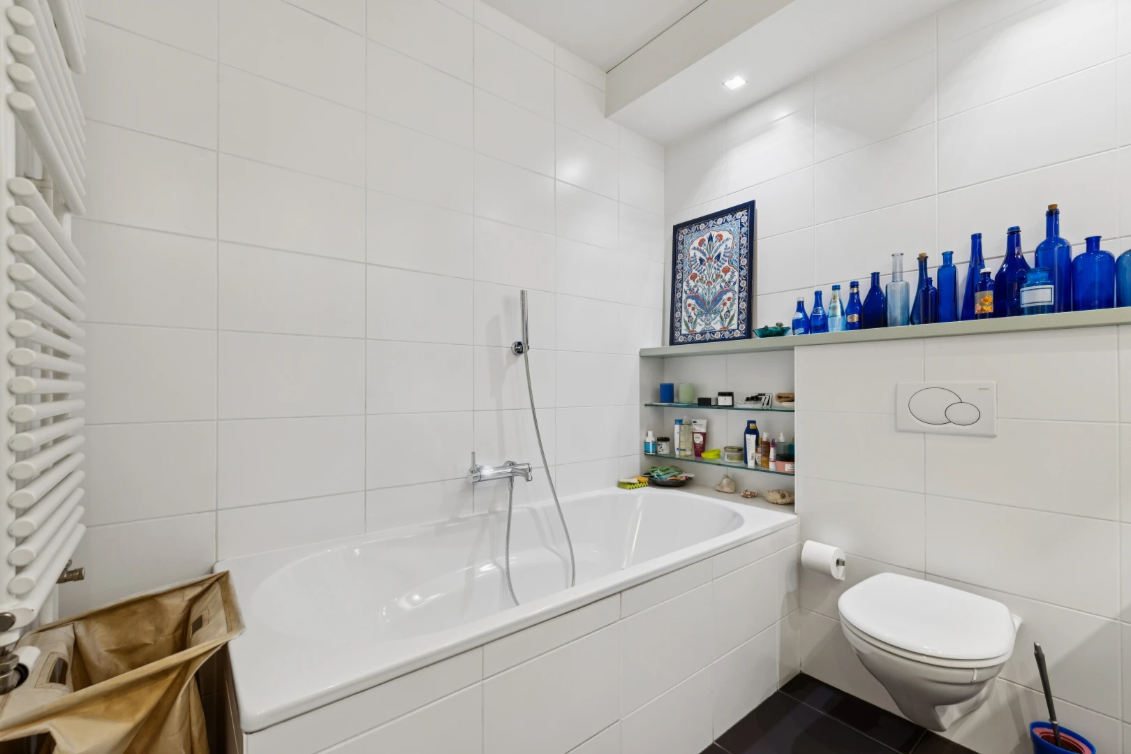 full bathroom with tile walls, radiator heating unit, a garden tub, and recessed lighting