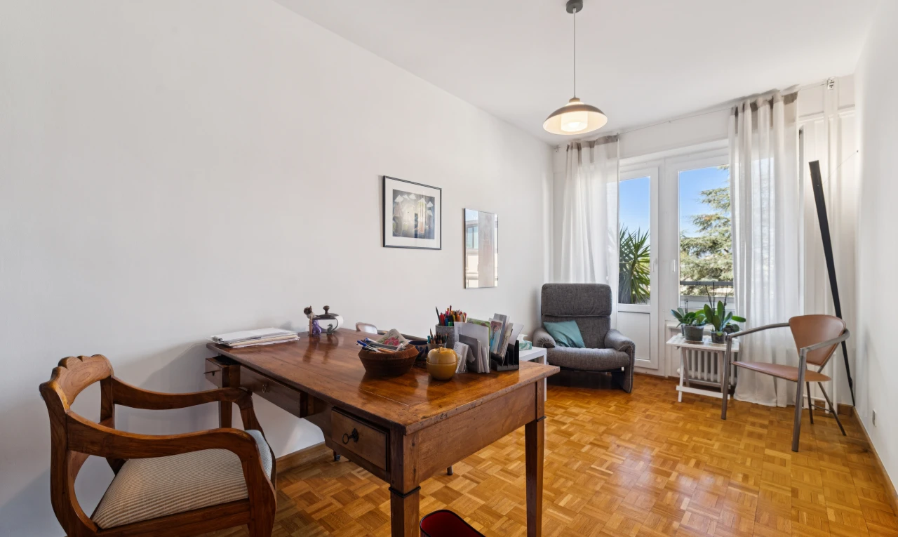 dining space featuring hanging light fixtures and parquet floors