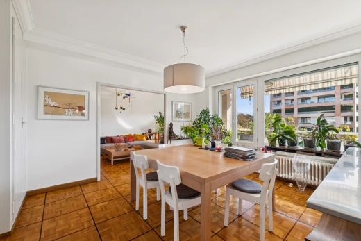 dining space featuring hanging light fixtures, radiator heating unit, ornamental molding, and parquet flooring