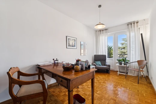 dining space featuring hanging light fixtures and parquet floors