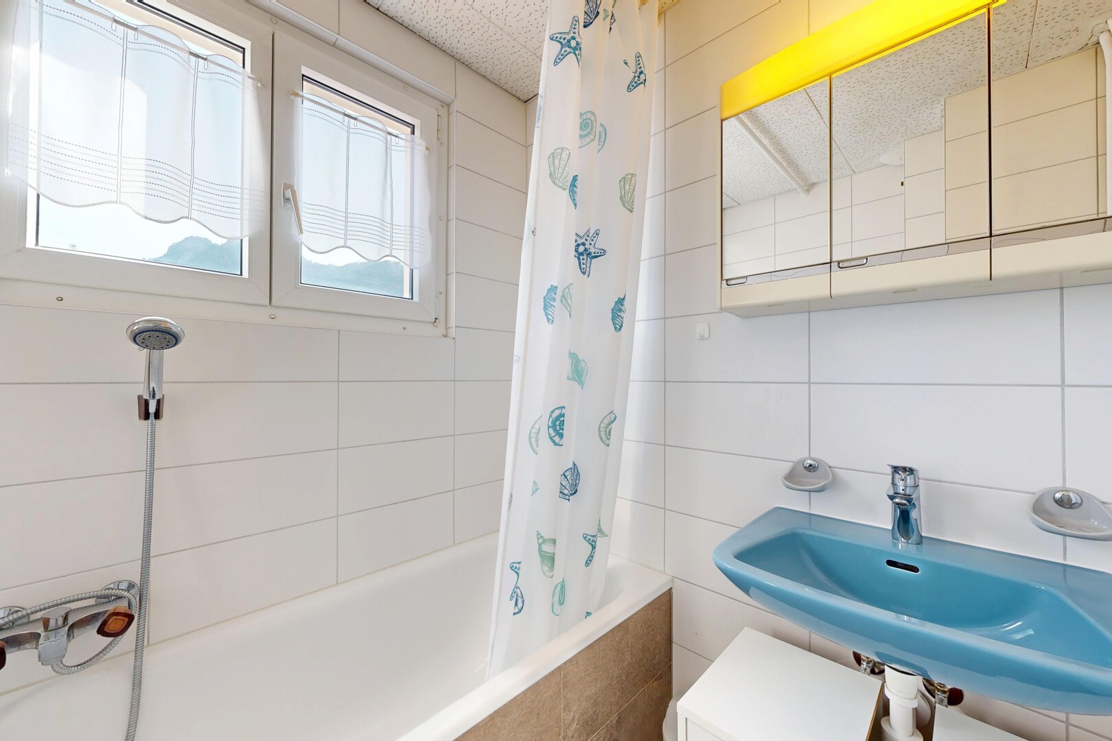 salle de bains avec tile wall, mur en carrelage, douche-bain combinés, évier, et salle de bain complète