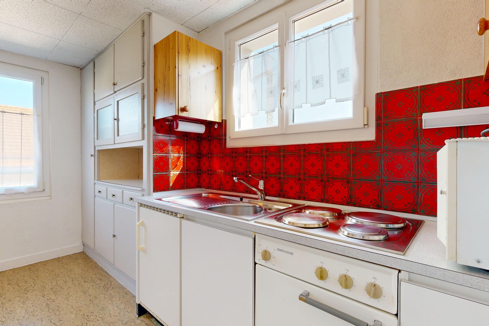 cuisine avec dosseret, backsplash, white cabinets, armoires blanches, et light floor